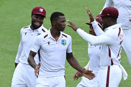 Shamar Joseph celebrates with West Indies teammates after taking the wicket of Alex Carey