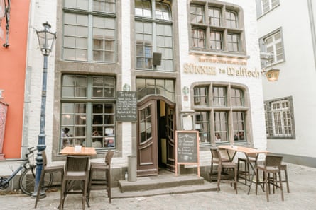 Exterior of an old tavern with tables outside