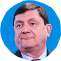 man in suit looking to side with blue background