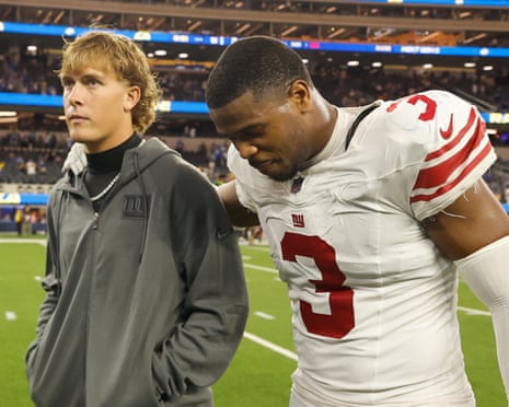 Jaxson Dart walks off the field Monday night with teammate Abdul Carter after the Giantsâ loss.