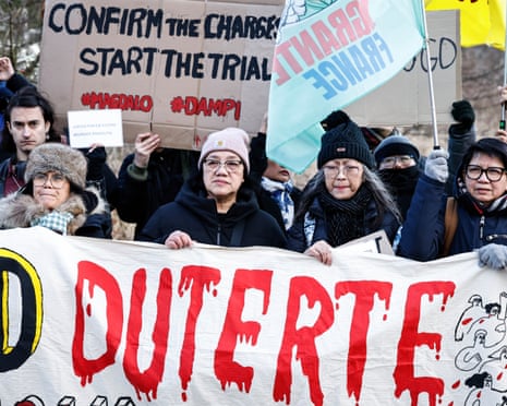 Banner reading Duterte painted in dripping red letters, with placard behind reading Confirm the Charge, Start the Trial