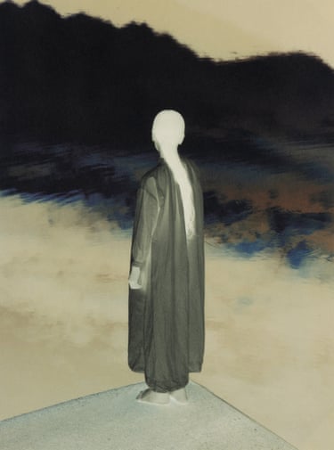 a woman’s back on edge of dock facing water