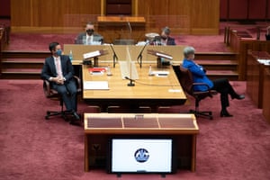 Penny Wong has her back turned away from Simon Birmingham in the Senate