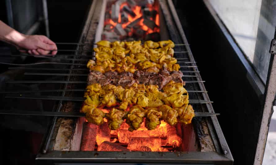 A variety of meat skewers are cooked over hot coals at Kabab Al Hojat