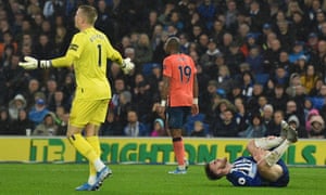 Everton’s goalkeeper Jordan Pickford gestures as Brighton’s Aaron Connolly lies on the pitch injured after a challenge with Everton’s Michael Keane. VAR decided there was enough contact for a penalty.