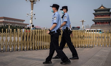 Police officers patrol Beijing’s Tiananmen Square on World Press Freedom Day.