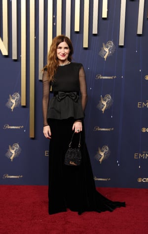 In a sober departure from her character’s wild looks, outstanding supporting actress in a comedy nominee Kathryn Hahn (The Studio) wears a bow on top of her peplumed Valentio gown