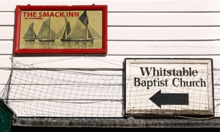 Signs for The Smack Inn and Baptist Church on a building in Whitstable, Kent.