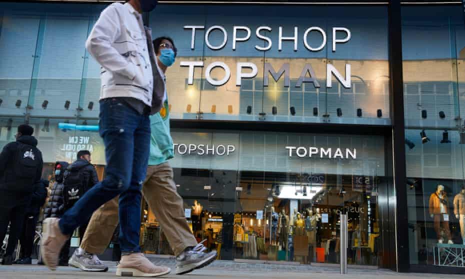 Shoppers pass Topshop in Leeds, West Yorkshire.
