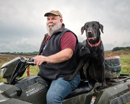 Farmer derek gow and his dog on a quad bike