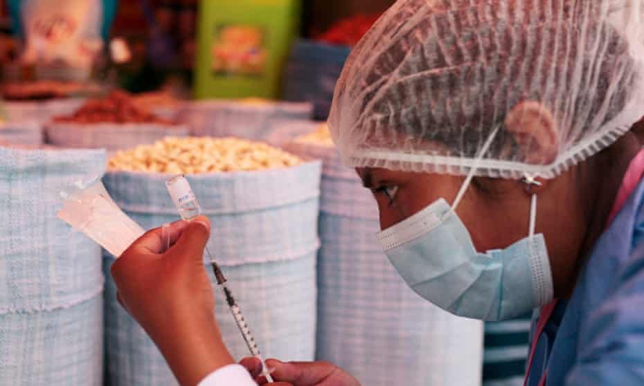 Health worker prepares vaccine