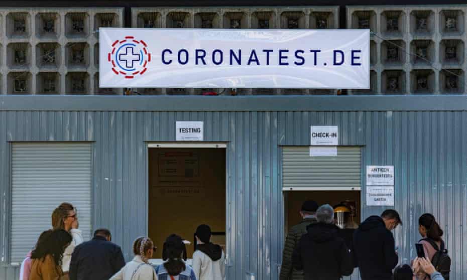 People wait in front of a coronavirus testing centre in Berlin