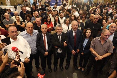 Head of the Joint List alliance Yousef Jabareen (C) with supporters as the first exit polls are announced at the alliance's campaign headquarters in Nazareth, Israel, 27 October 2026.