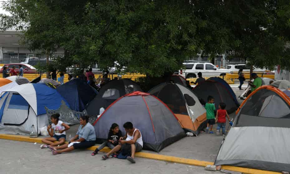 Migrants, many of whom were sent back to Mexico under Migrant Protection Protocols, at a makeshift encampment in Matamoros, Mexico, on 24 August. 