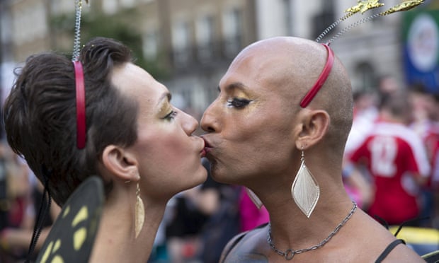 Participants kiss as they take part in the annual Pride London parade.