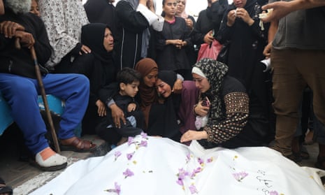 Relatives of Palestinians killed in Israeli attacks mourn as they receive the bodies from a hospital morgue for burial in Dair El-Balah, central Gaza