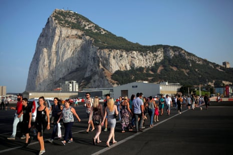 Pedestrians cross the tarmac at Gibraltar Airport in front of the Rock near the border with Spain in the British overseas territory of Gibraltar.