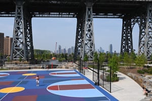 People playing basketball under the bridge
