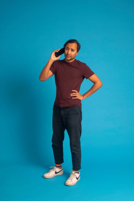 Rhik on the phone against a blue background