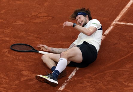 Alexander Bublik falls to the floor as the emotion engulfs him after beating Jack Draper.