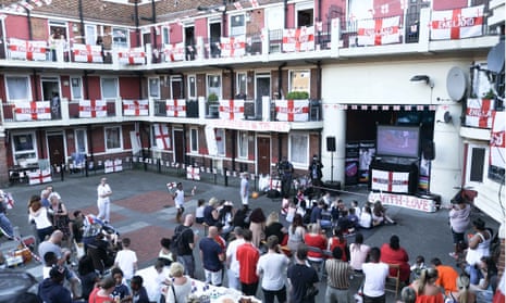 Football fans watch on a big screen at the Kirby Estate in Bermondsey, London.