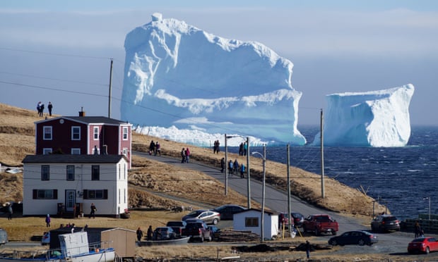 Residents view the first iceberg of the season as it passes the south shore, also known as ‘iceberg alley’, near Ferryland, Newfoundland.
