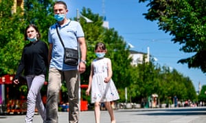 A family in Kosovo walks in the center of Pristina.