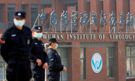 Security staff keep watch outside the Wuhan Institute of Virology in February 2021 during a visit by the World Health Organization team who investigated the origins of Covid-19. 