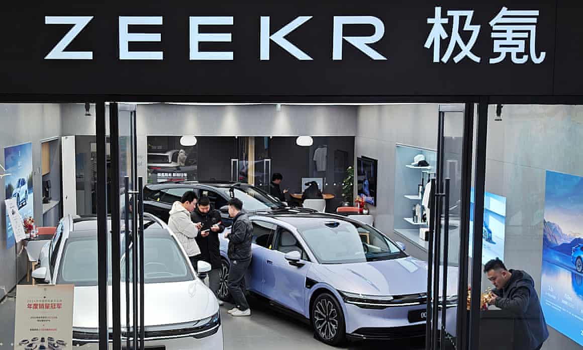 People and cars in a Zeekr showroom