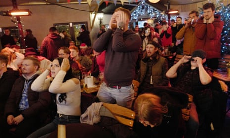England fans watch Harry Kane miss his penalty and their team lose to France in the Wood House pub.