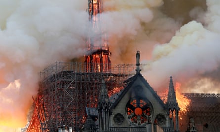 Smoke billows as fire engulfs the spire of Notre Dame cathedral on 15 April 2019.