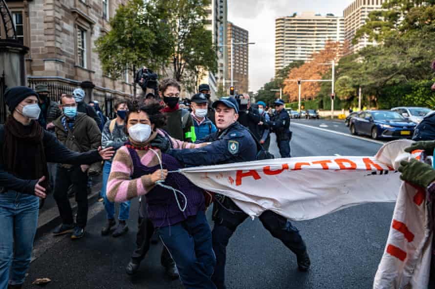 Police officers disperse protesters during a Blockade Australia protest in Sydney, Tuesday, June 28, 2022.