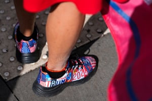 A supporter of former president Donald Trump waits for Trump’s motorcade to arrive at Manhattan Criminal Court on Thursday wearing Trump 2024 shoes.