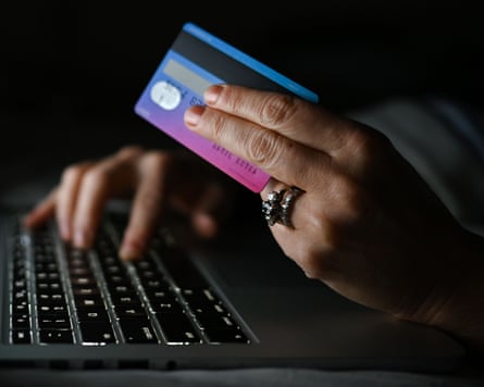 Person holding a credit card while shopping online
