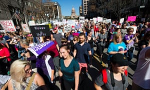 Protesters march down Congress Street in Austin as they take part in the Austin Women’s March.