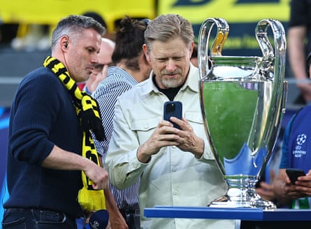Jamie Carragher and Peter Schmeichel with the Big Cup trophy in Dortmund.