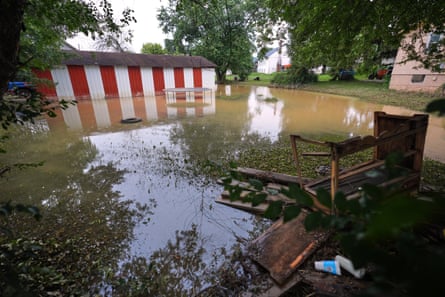 outdoor furniture floats in floodwaters outside home