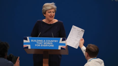 Prankster interrupts Theresa May's conference speech to hand her fake P45 – video