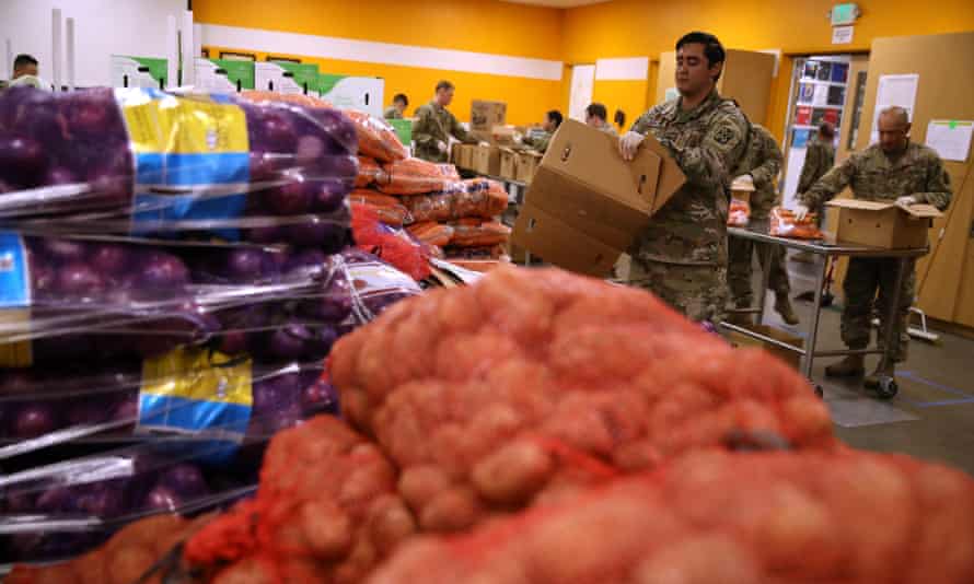 Members of the California national guard help pack boxes of fruits and vegetables at Second Harvest food bank in San Jose, California.