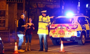 Police stand by a cordoned off street close to the Manchester Arena