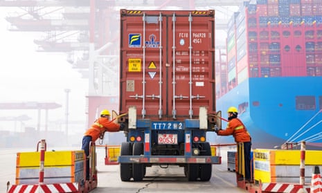 Workers prepare a container at the port in Qingdao, China