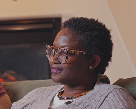 A woman with short hair and glasses on a couch