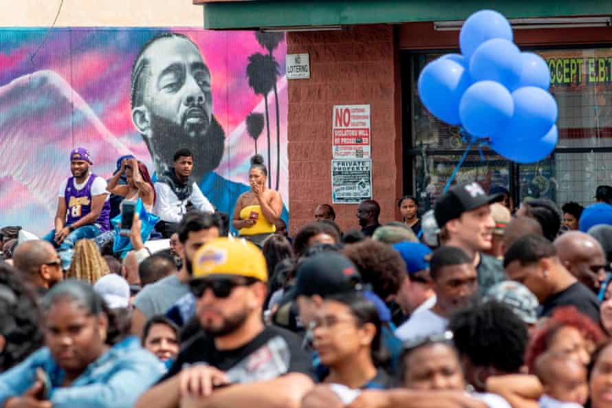 Fans and community members gather along the procession route for Nipsey Hussle after his memorial at the Staples Center in Los Angeles, California, on 11 April 2019.