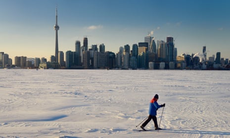 The frozen Lake Ontario with Toronto skyline in the background.