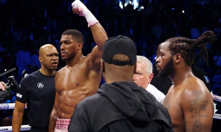 Anthony Joshua celebrates victory over a dejected Jermaine Franklin