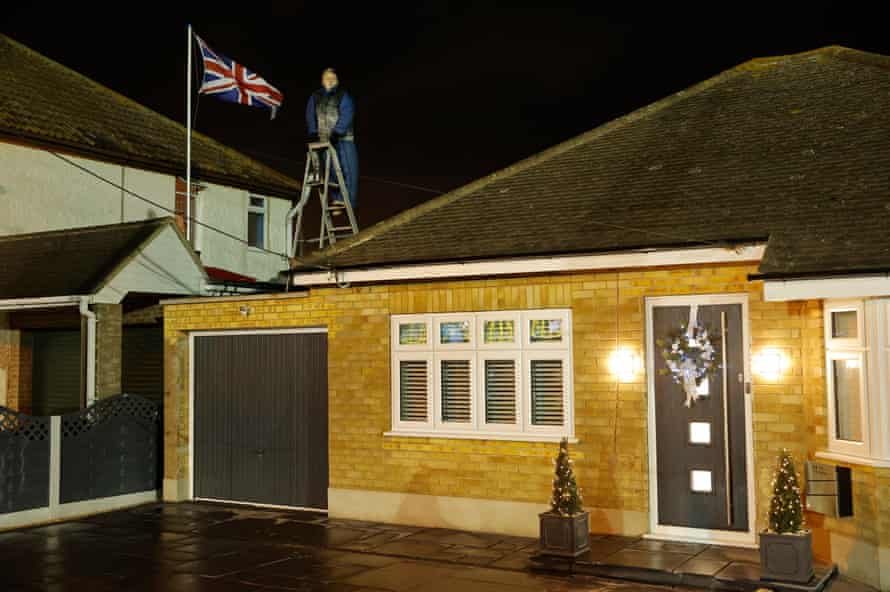 Steve Marks watches from a ladder on his garage roof during the Canvey Island v Boreham Wood FA Cup second-round tie at Park Lane on 30 November.