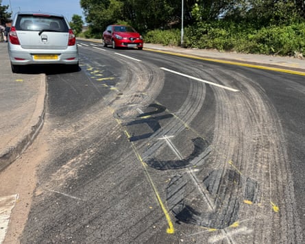 Residential road with signing on it painted over in black.