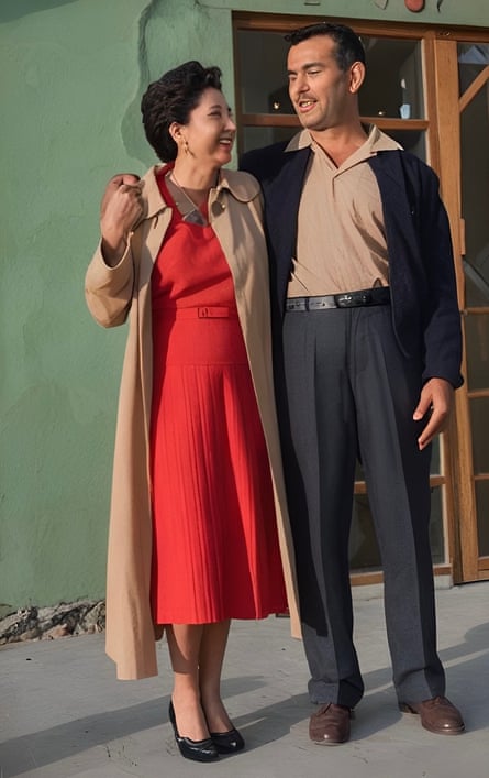 man and woman look at each other with arms around one another