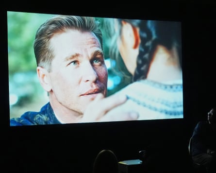 People watch a trailer for the upcoming film “As Deep as the Grave” featuring a character played by a generative AI version of Val Kilmer