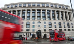 Traffic and people pass by the front of the Unilever building by Blackfriars bridge in central London.